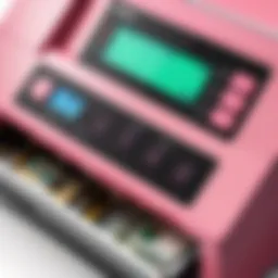 Close-up of pink money counter machine showcasing its digital display and buttons.